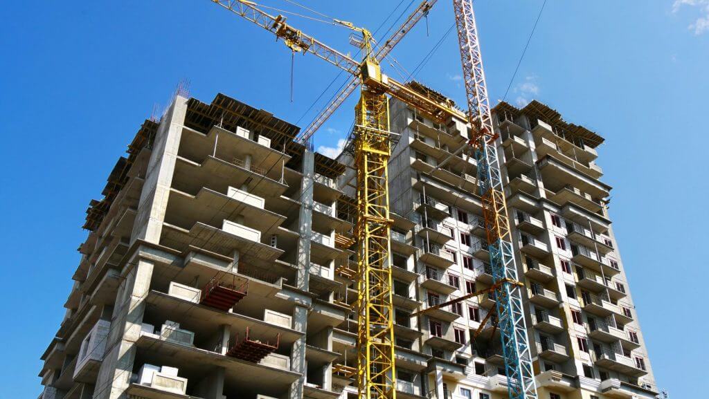 Skyscraper Construction. Two Cranes Near Building Under Construc